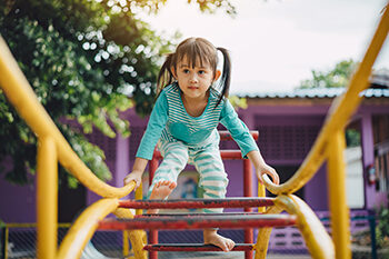 Child having fun climbing at the playground